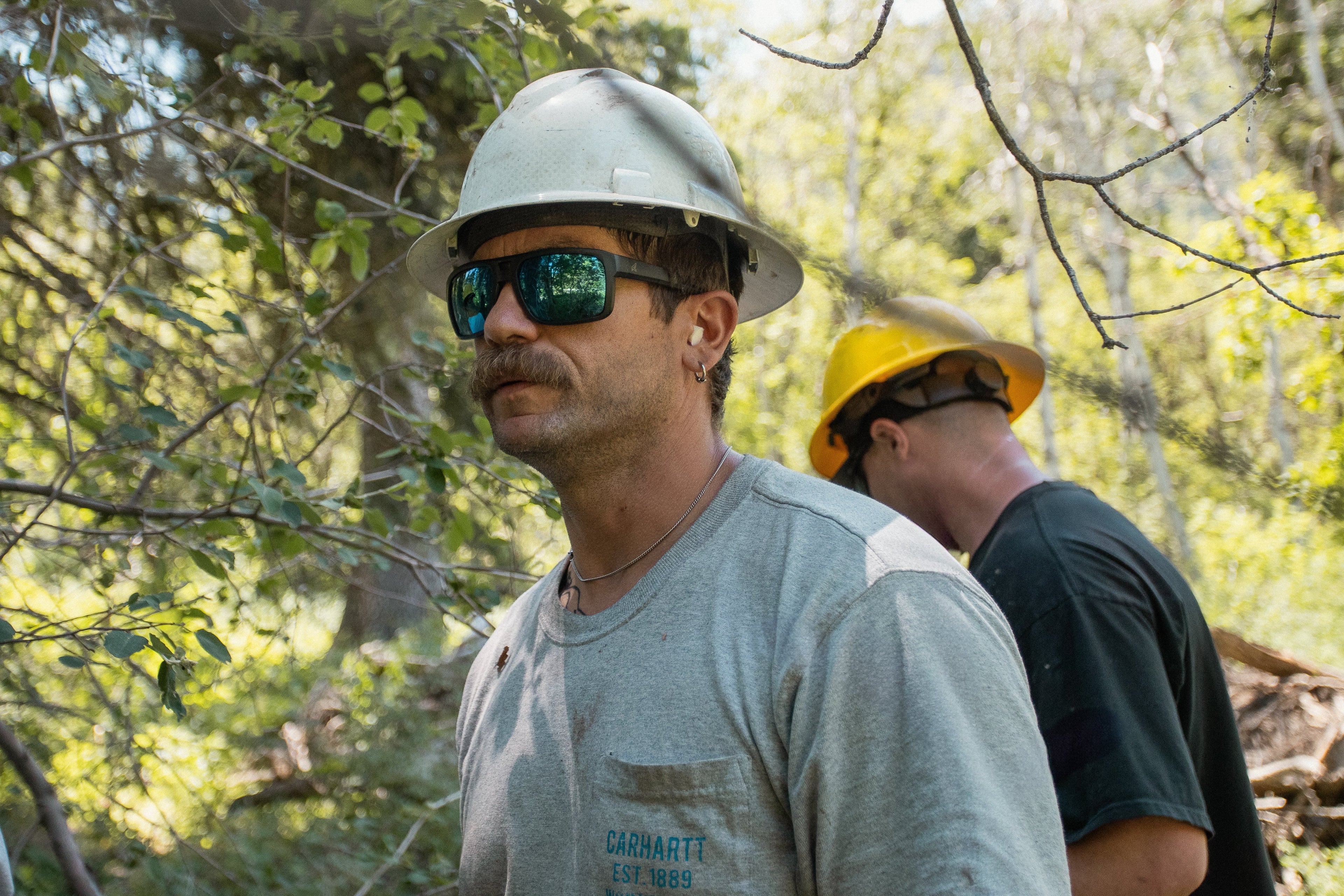 Man Wearing Safety Glasses and Protective Gear With Hard Hat and Other PPE