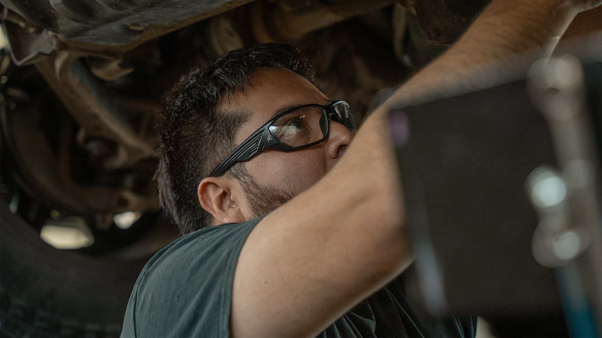 Person Wearing Safety Glasses Working Under Car
