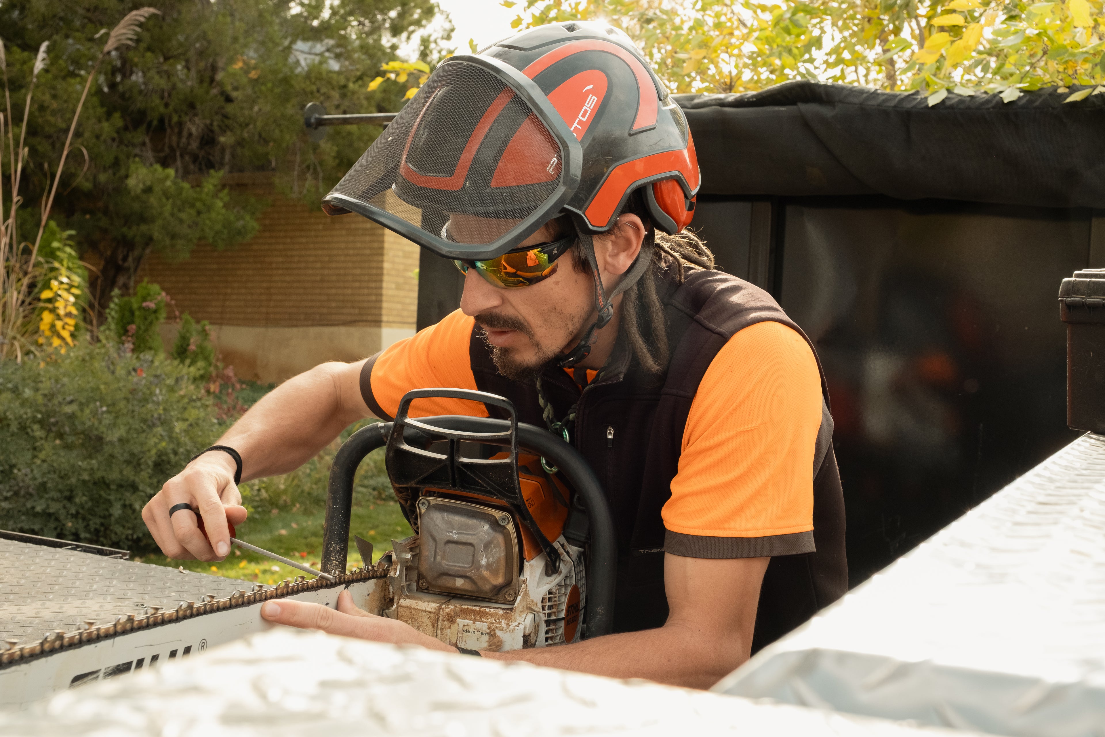 Person using a chainsaw in an outdoor setting
