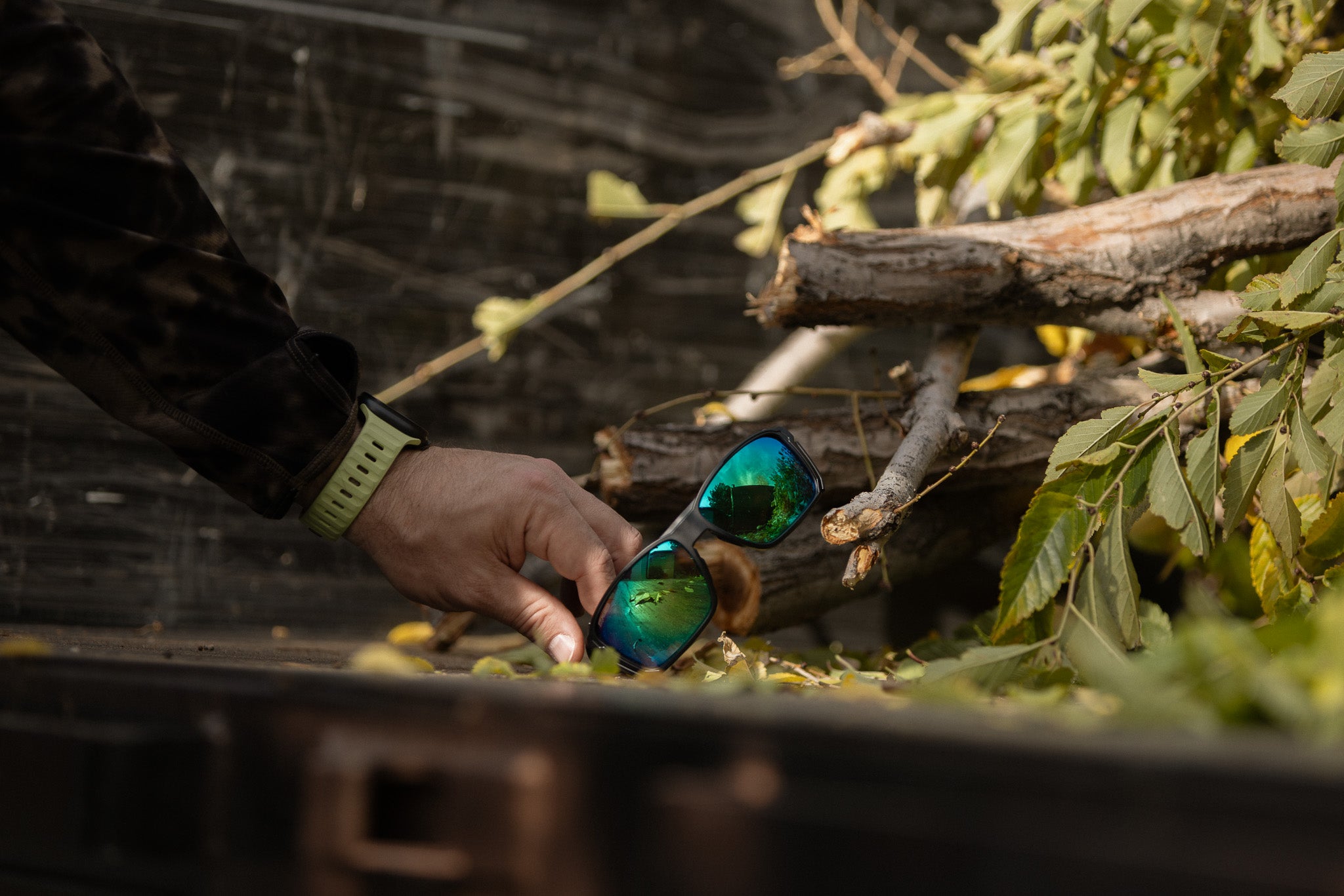 hands grabbing a pair of safety glasses in an arborist truck