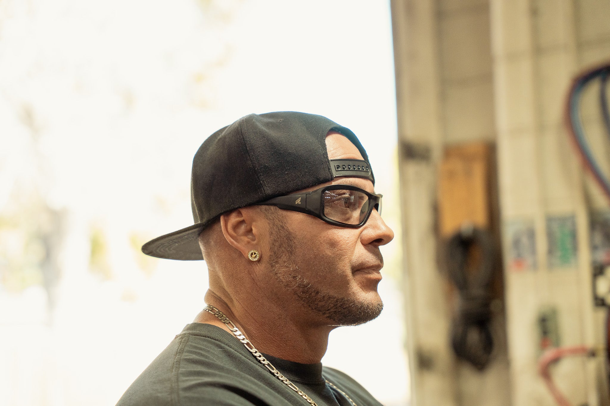 Man wearing safety glasses and baseball cap