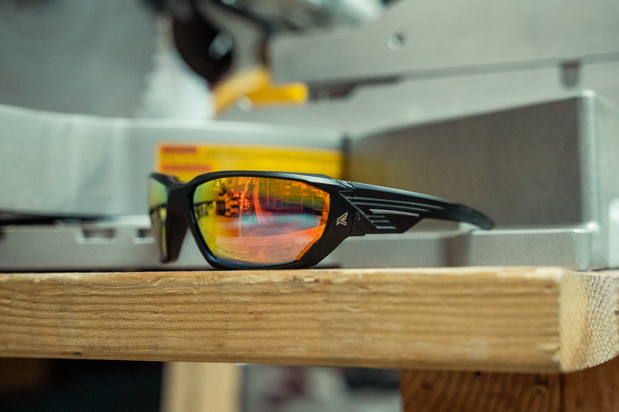 red mirror safety glasses sitting on workbench