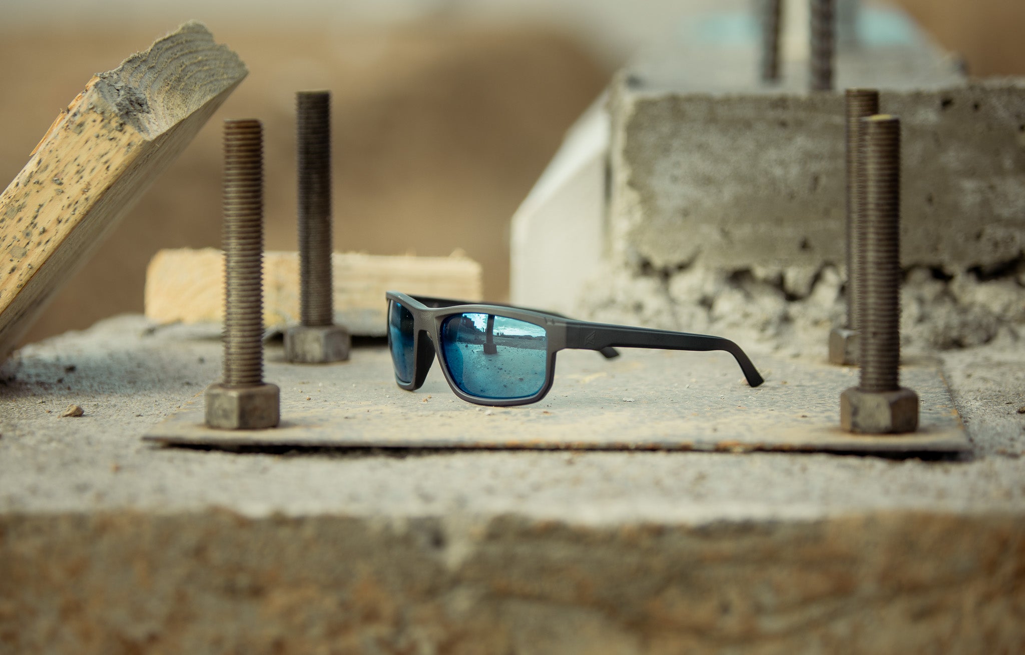 blue lens safety glasses on concrete surface