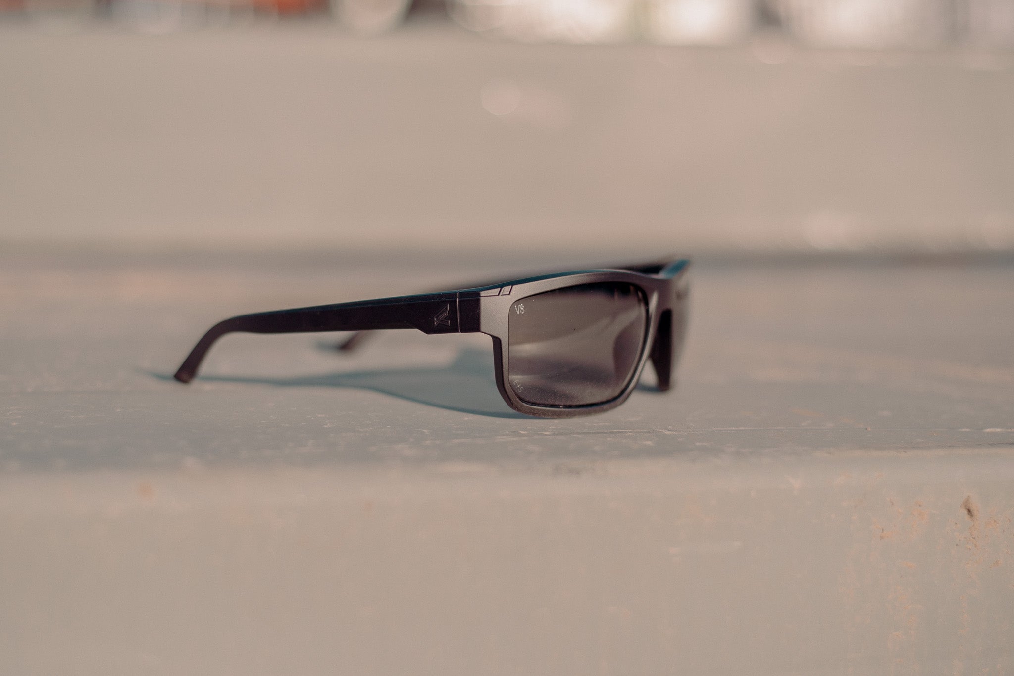 black anti-fog sunglasses on metal surface