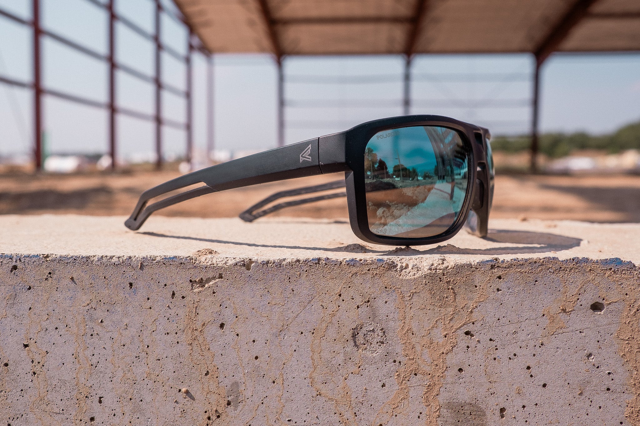 blue lens safety glasses sitting on concrete