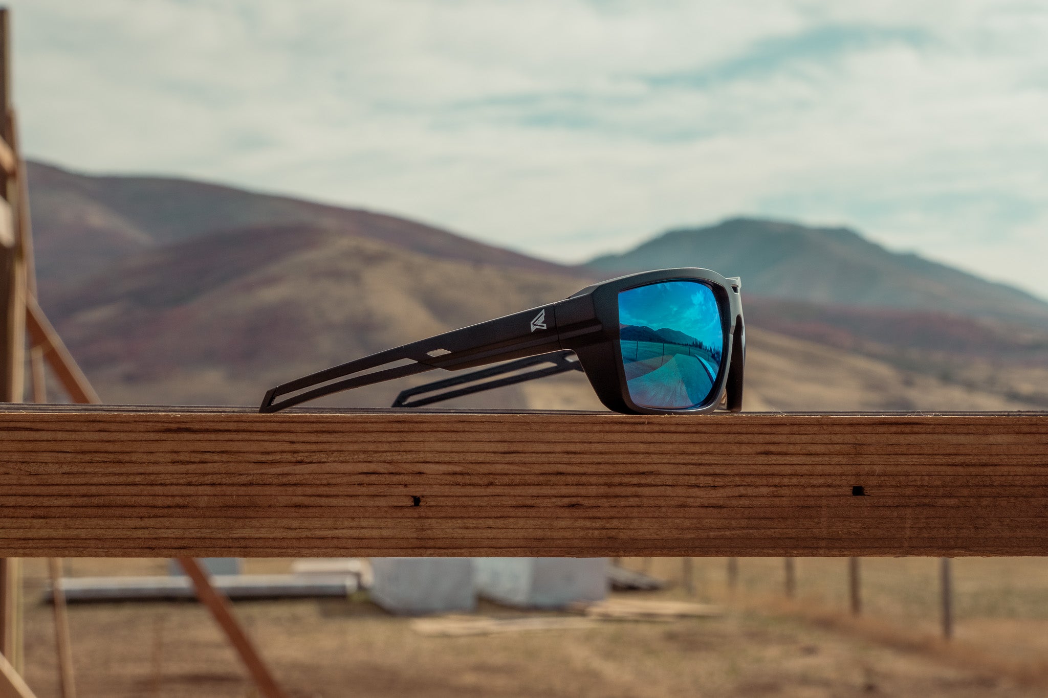 Safety Glasses with blue lenses on wood