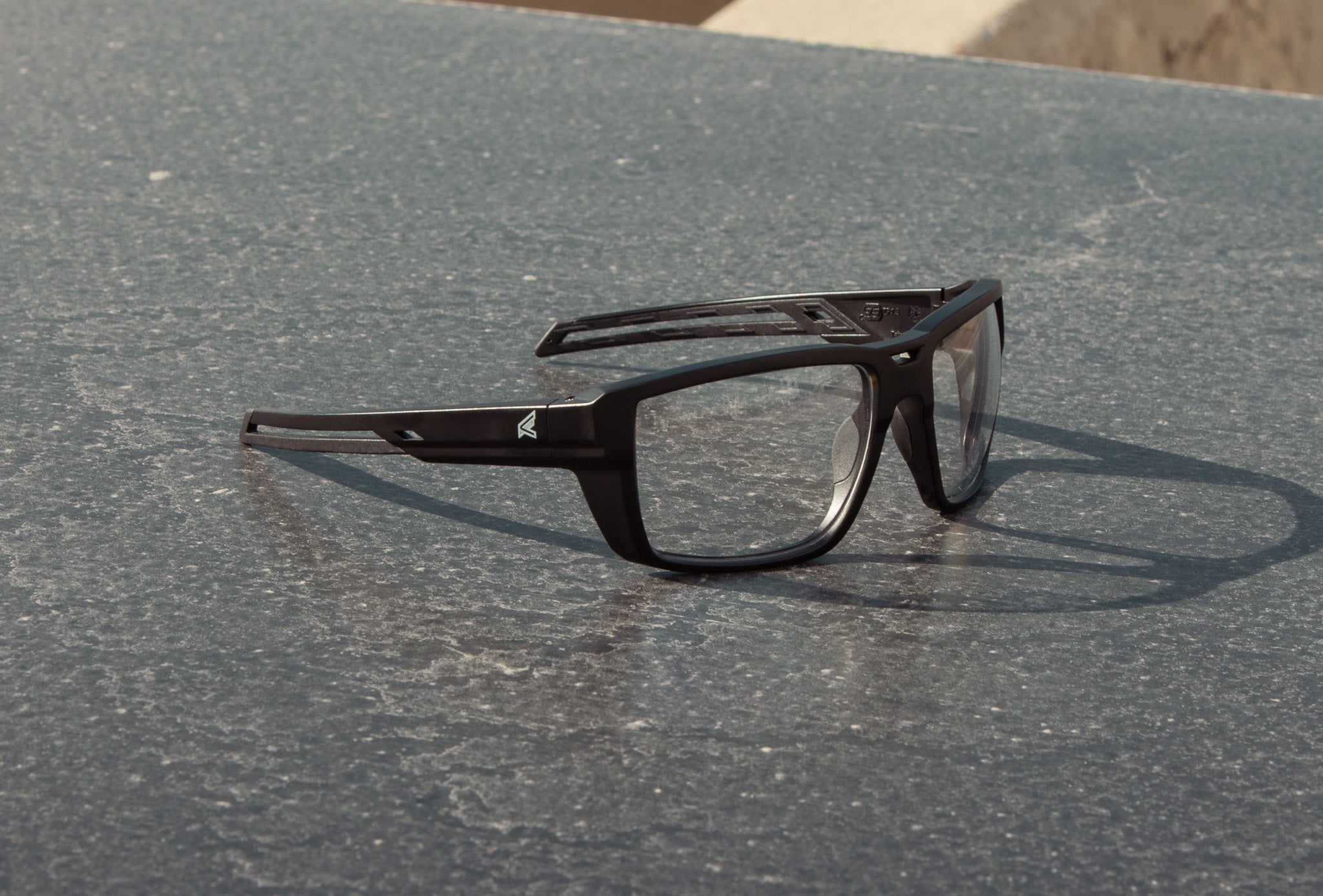 Black safety glasses on metal surface