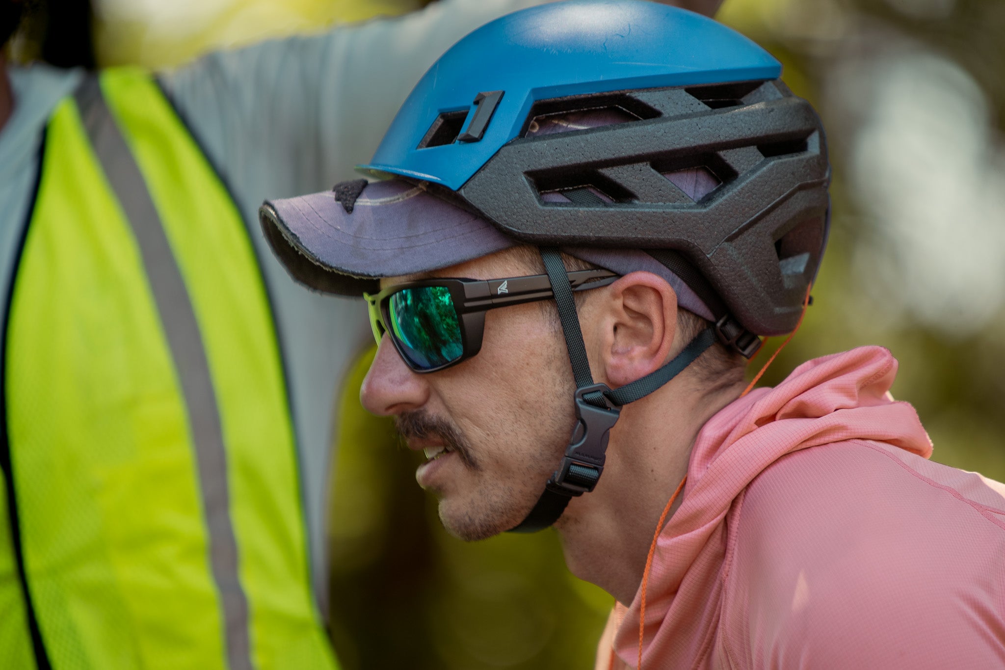 Person wearing a blue helmet and safety glasses