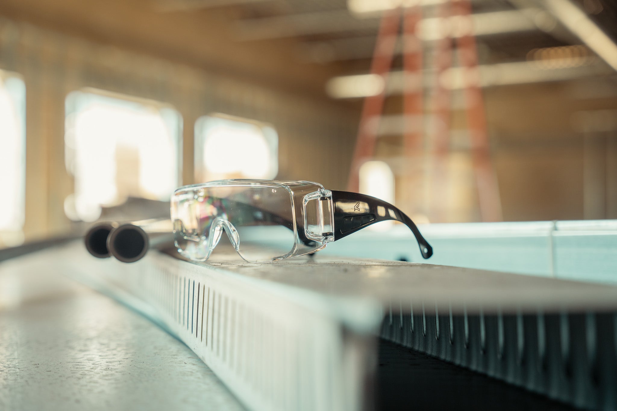 Safety goggles on a table with a blurred background