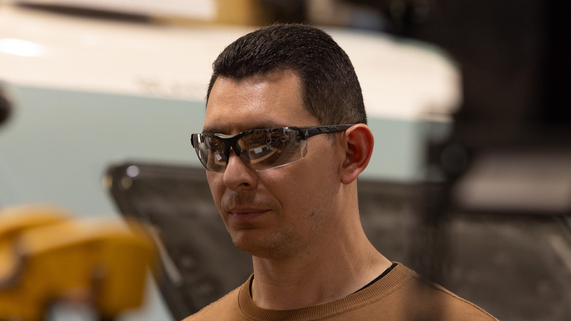 Man wearing anti reflective safety glasses indoors