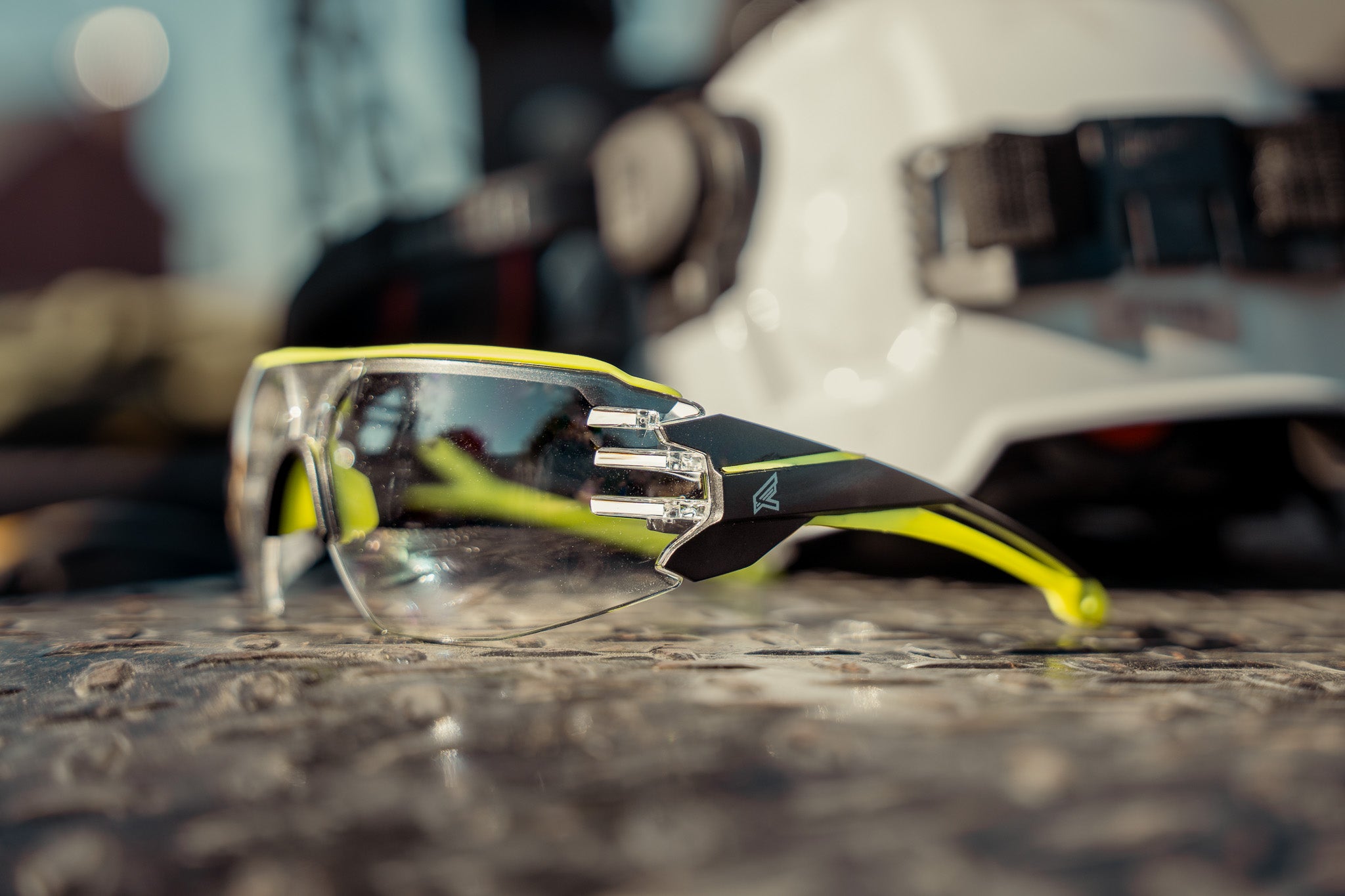 safety glasses with hi-vis yellow accents sitting on toolbox outside