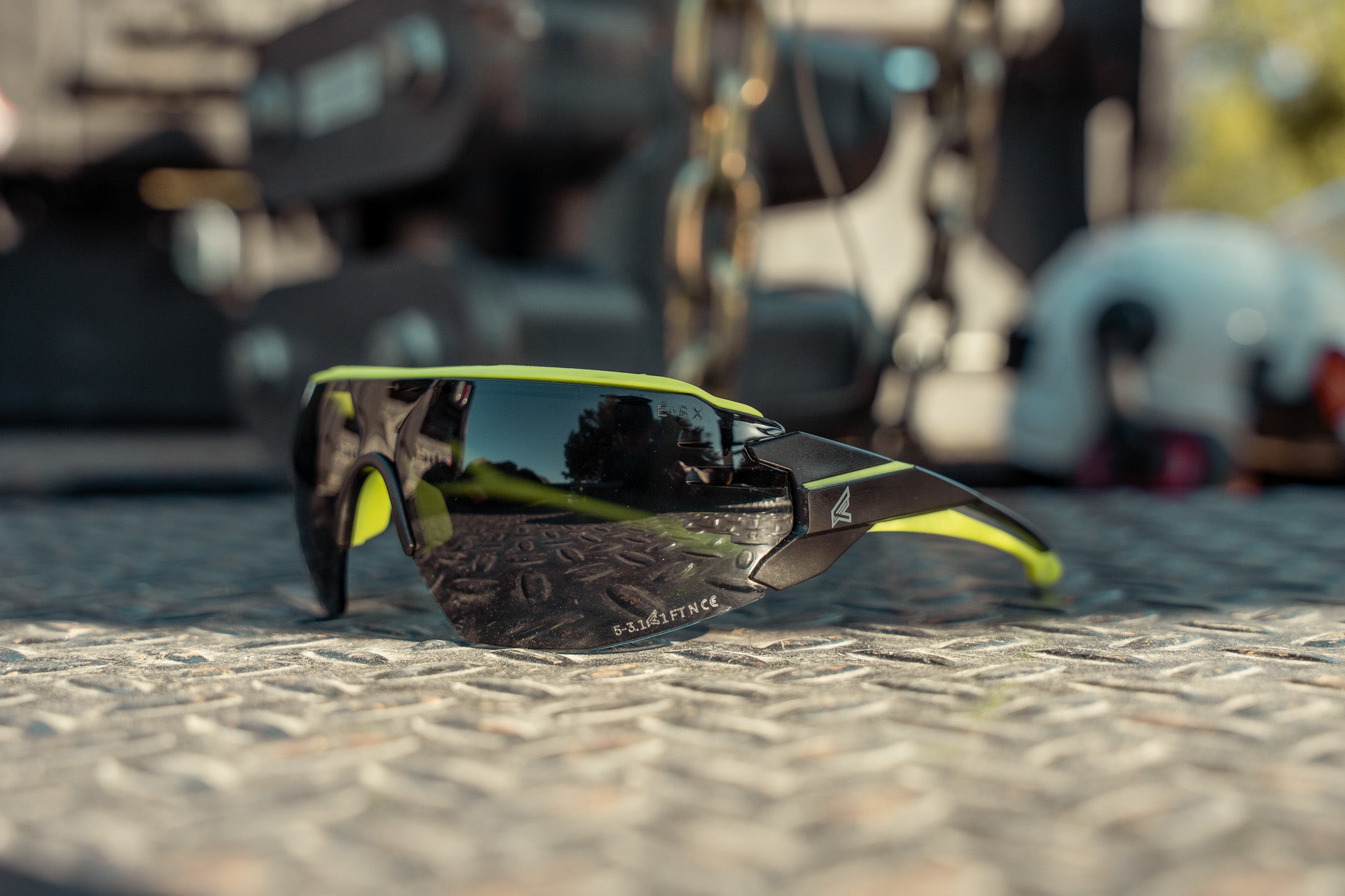 black and yellow safety glasses on diamond plate toolbox outdoors